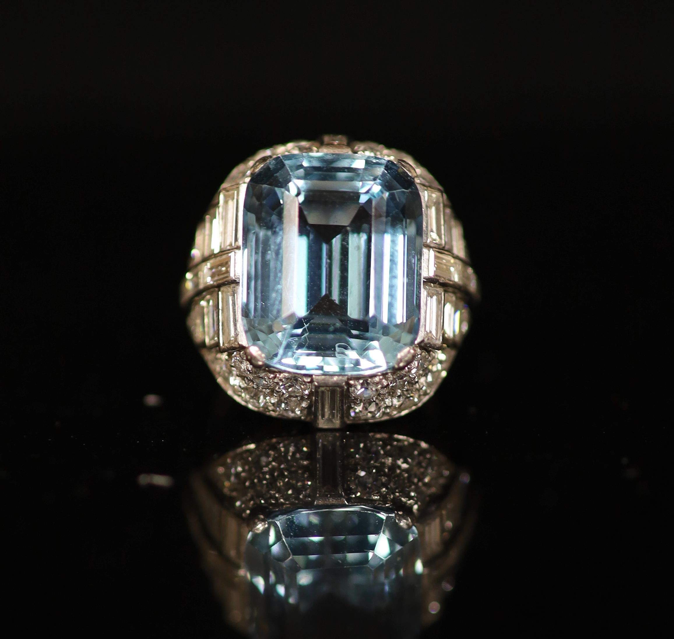 A 1930's/1940's platinum?, emerald cut aquamarine, round and baguette cut diamond set dress ring